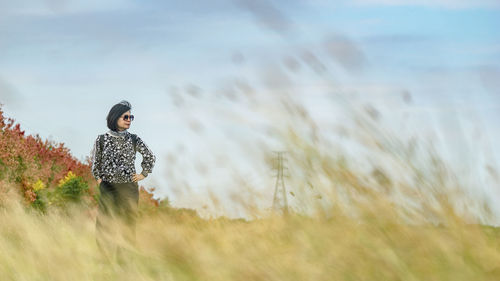 Woman looking into the sky in the autumn season