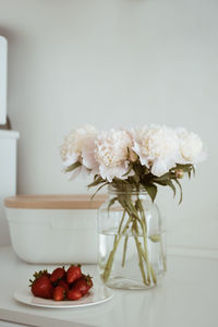 Close-up of white roses in vase on table