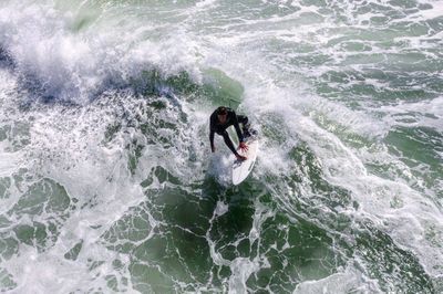 High angle view of man surfing in sea