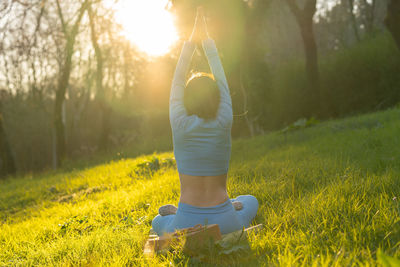 Rear view of woman walking on field