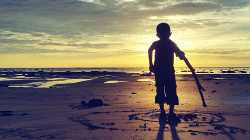 Rear view of a boy on beach