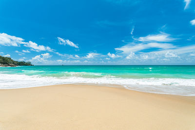 Scenic view of beach against blue sky