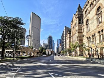 City street and buildings against sky