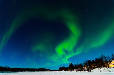 Scenic view of snowy landscape against sky at night