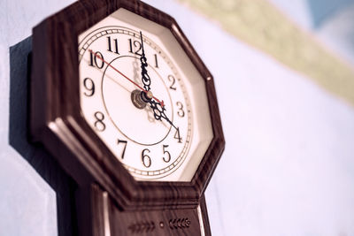 Low angle view of clock on wall