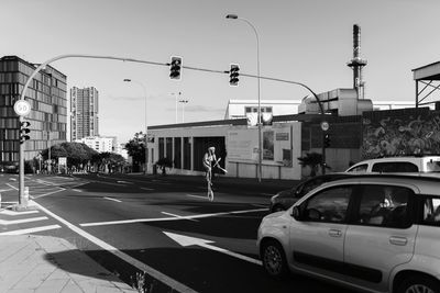 Cars on road against buildings