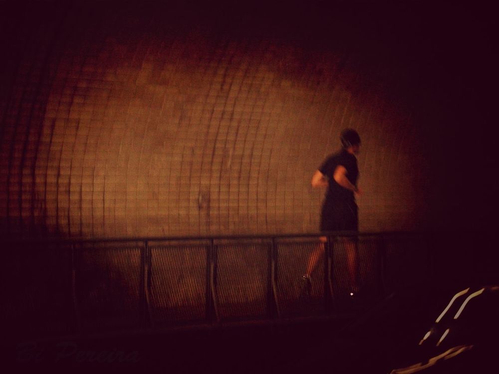 silhouette, lifestyles, standing, leisure activity, indoors, wall - building feature, built structure, men, architecture, full length, dark, shadow, side view, railing, night, sunlight, person, copy space