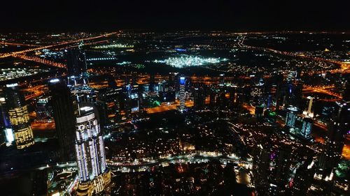 High angle view of illuminated city buildings at night