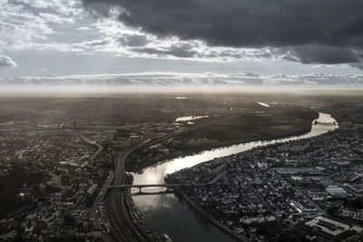 High angle view of river amidst buildings against sky