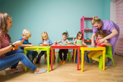 Teachers teaching students at nursery