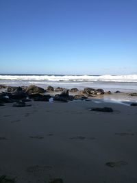 Scenic view of beach against clear sky