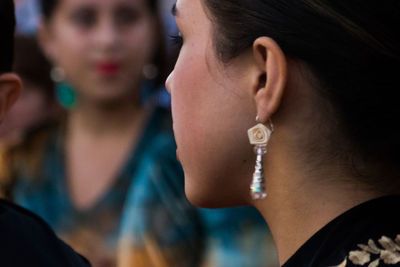 Close-up of women looking away while talking during festival