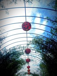 Low angle view of lanterns hanging against sky