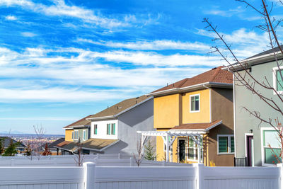 Houses in town against sky