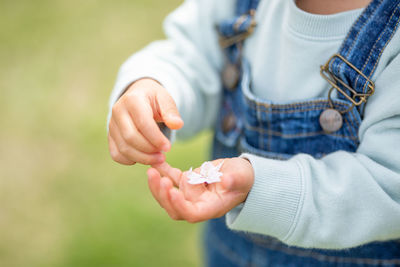 Midsection of couple holding hands