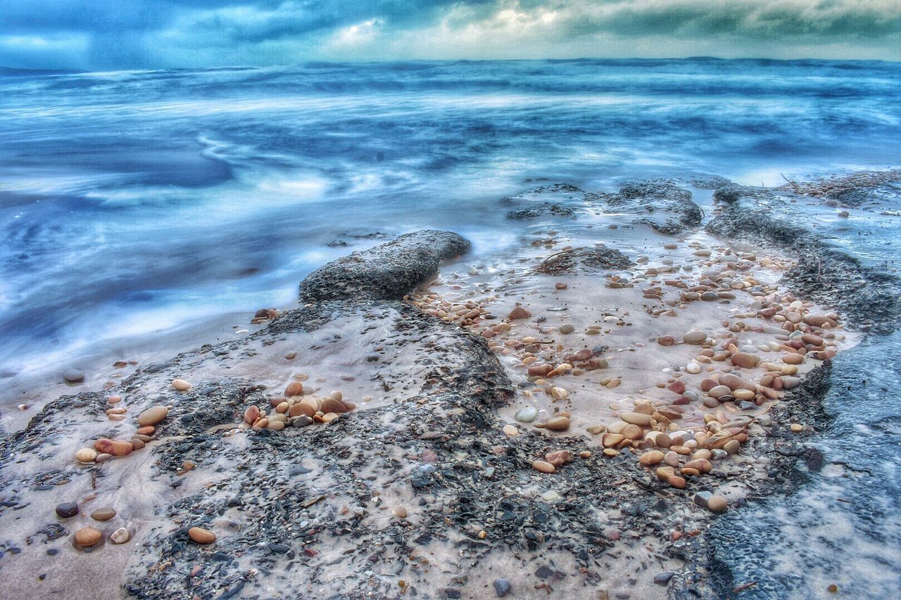 CLOSE-UP OF ROCKS IN SEA