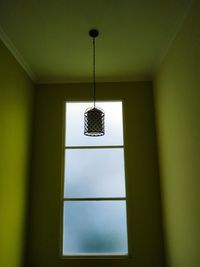 Low angle view of pendant light hanging in building