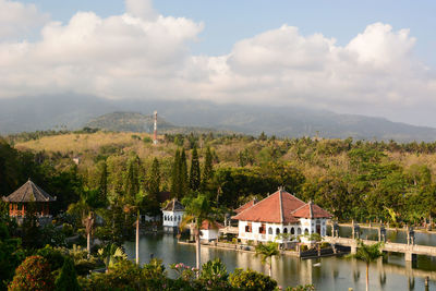 High angle view of townscape by lake against sky