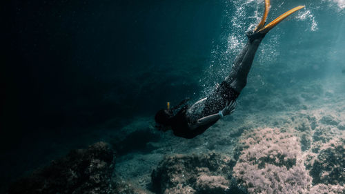 Full length of woman diving undersea