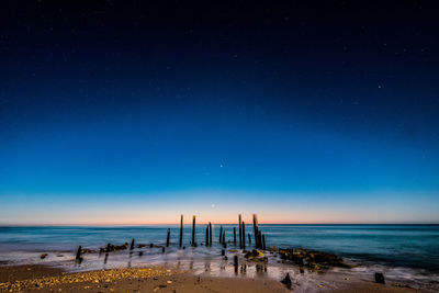 Scenic view of beach against blue sky