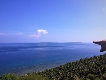 Scenic view of sea against blue sky