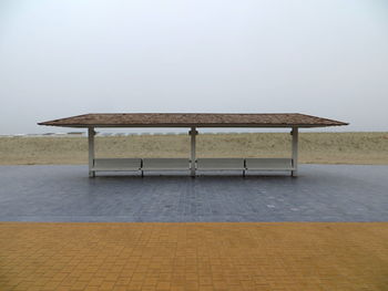 Lifeguard hut on beach against sky