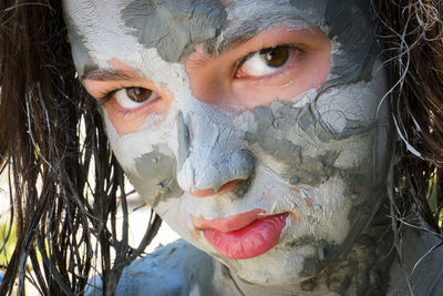 Close-up portrait of girl with facial mask on face