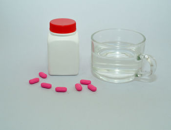 Close-up of glass bottle against white background