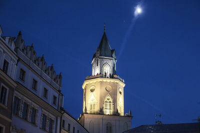 Low angle view of bell tower against blue sky