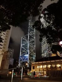 Low angle view of illuminated buildings against sky at night