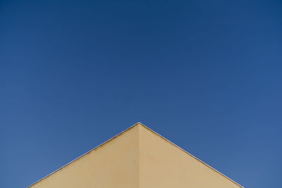 Low angle view of building against clear blue sky