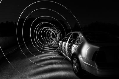 Car on illuminated road at night