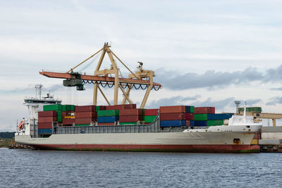 Commercial dock by sea against sky