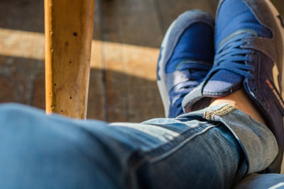 Low section of man sitting outdoors