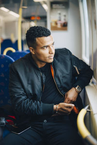 Man injecting insulin while sitting in train