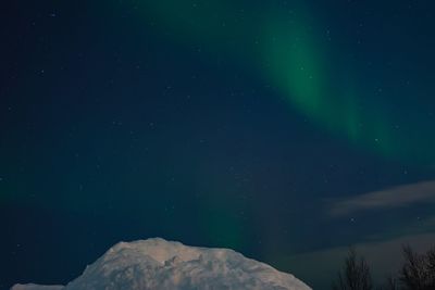 Low angle view of mountain against sky at night