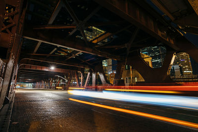 Light trails on bridge in city at night