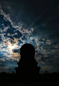 Low angle view of silhouette rock formation against sky during sunset