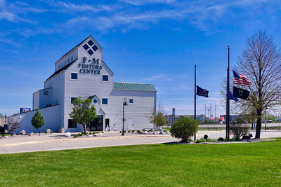 Building on field against blue sky