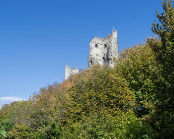 Low angle view of historic building against blue sky