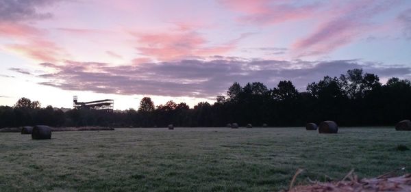 Hay bales on field against sky