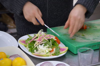 Midsection of man preparing food on table