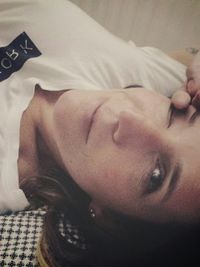 Close-up of young woman lying on bed