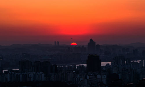 High angle view of cityscape against orange sky
