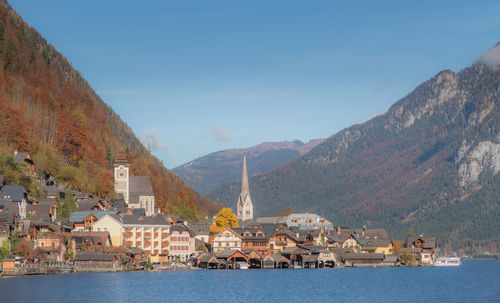 View of buildings by sea against sky