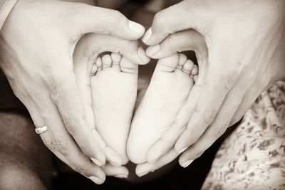 Close-up of father holding baby hand