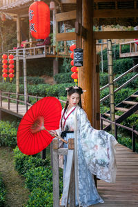 Portrait of woman standing against built structure