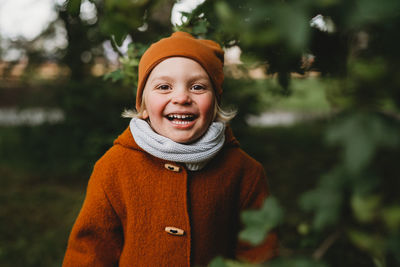 Portrait of a smiling young woman standing outdoors