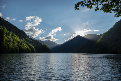 Scenic view of lake and mountains against sky