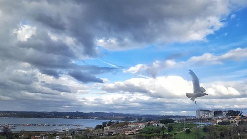 Cityscape against cloudy sky